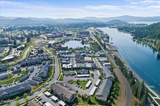 drone / aerial view featuring a water and mountain view