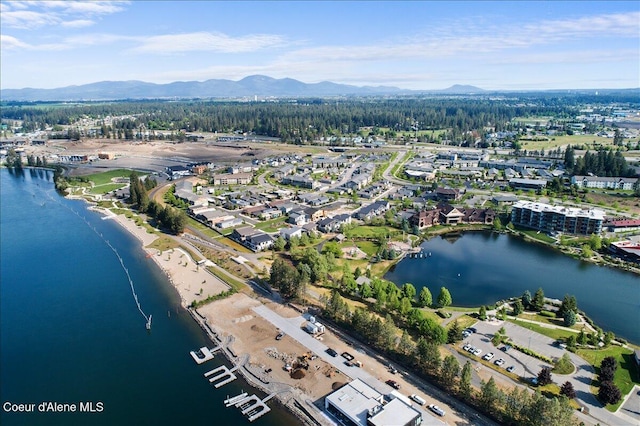 drone / aerial view featuring a water and mountain view