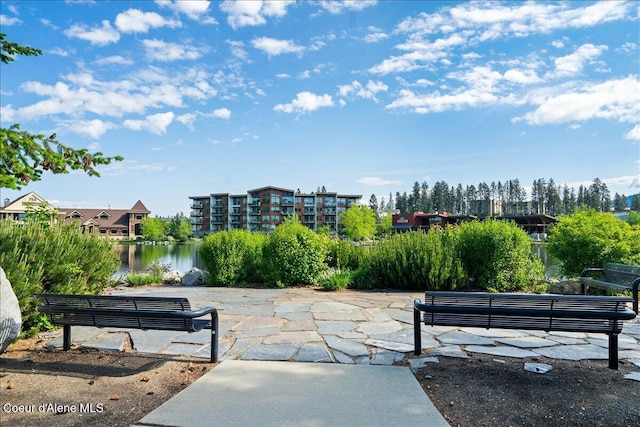 view of community featuring a water view and a patio