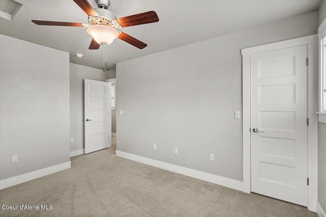 unfurnished bedroom featuring ceiling fan and light colored carpet