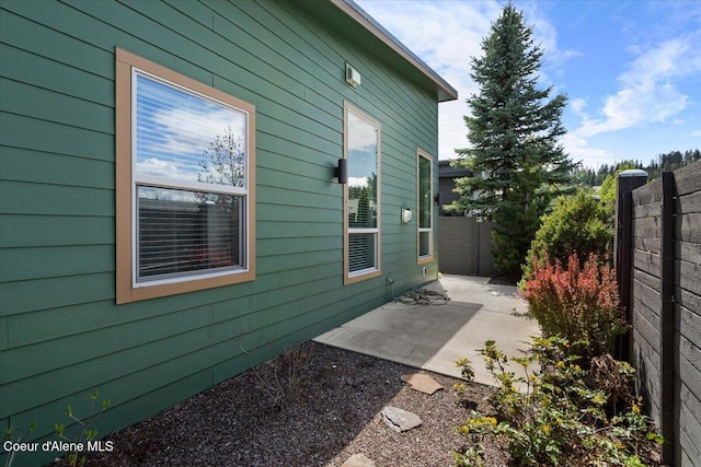 view of side of property with a patio