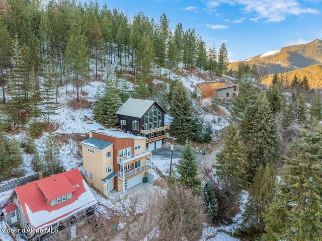 snowy aerial view featuring a mountain view