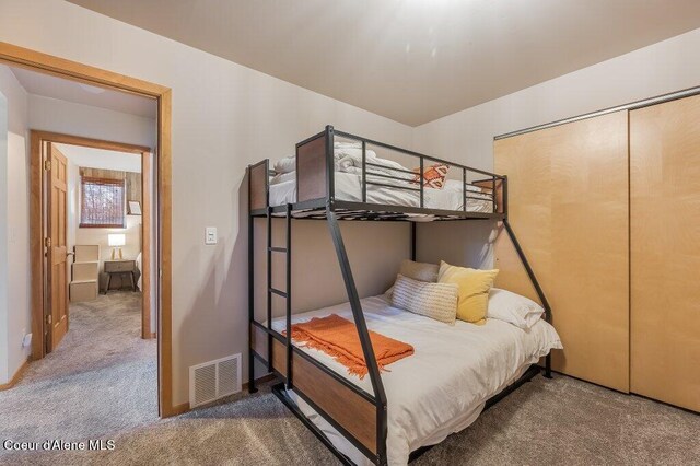 carpeted bedroom with a closet