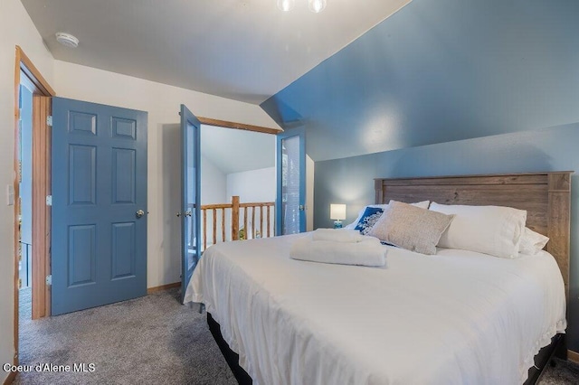 carpeted bedroom featuring lofted ceiling