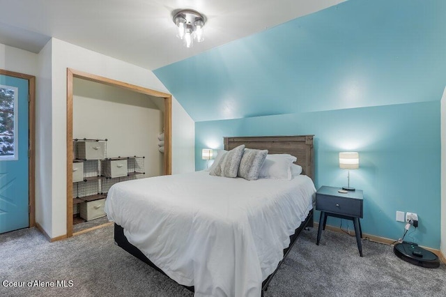 carpeted bedroom featuring vaulted ceiling