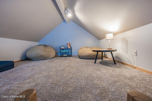 living area featuring lofted ceiling with beams and carpet