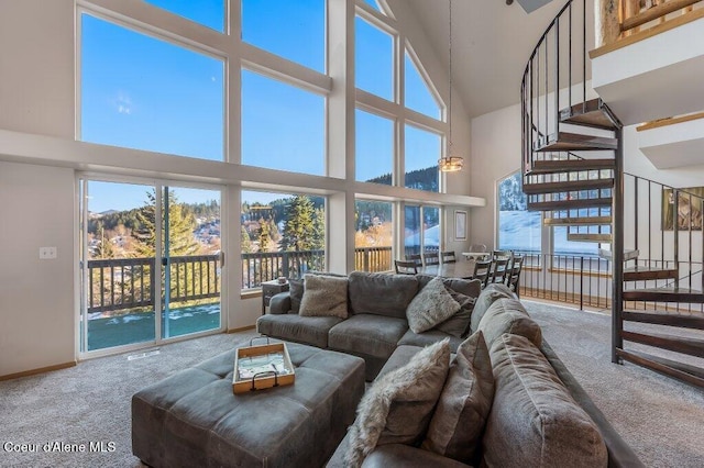 living room with a high ceiling and carpet