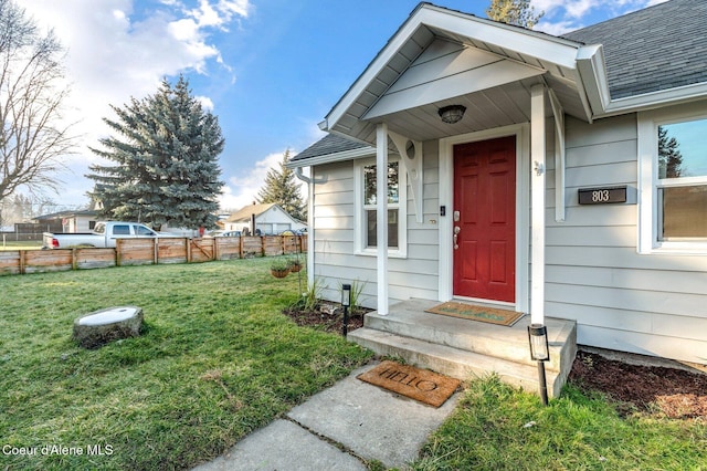 property entrance featuring a lawn