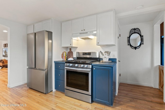 kitchen featuring light hardwood / wood-style flooring, blue cabinetry, stainless steel appliances, and white cabinetry