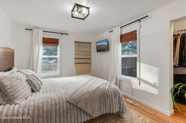 bedroom with hardwood / wood-style flooring