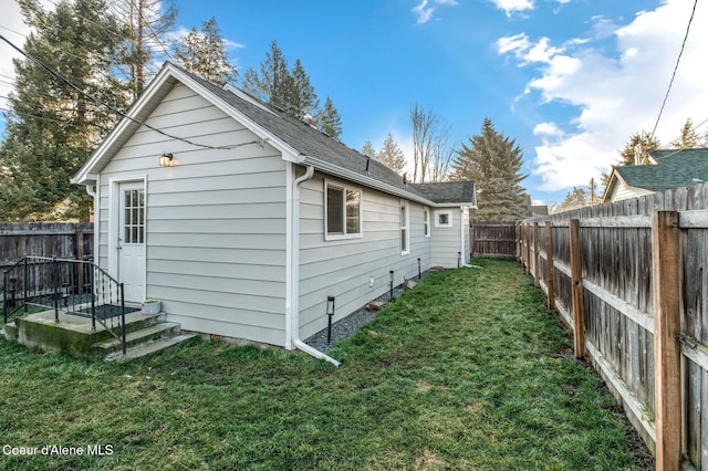 view of side of property with a yard