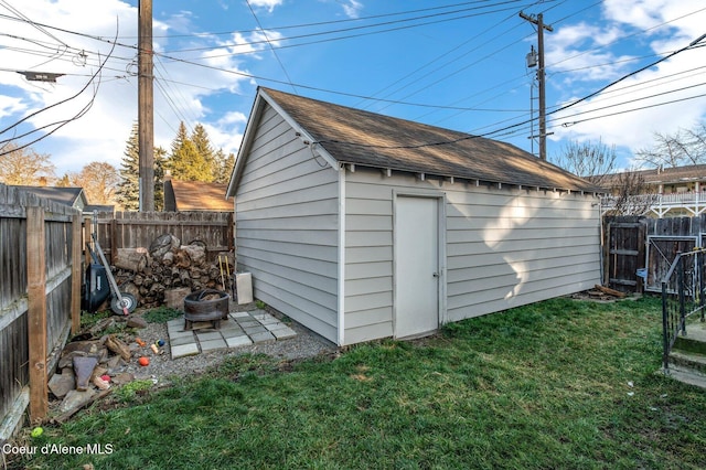 view of outbuilding featuring a yard and a fire pit