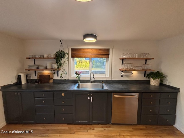 kitchen featuring light wood-type flooring, dishwasher, and sink