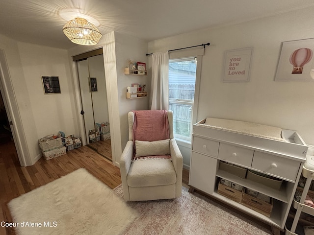 sitting room with a wealth of natural light and hardwood / wood-style flooring