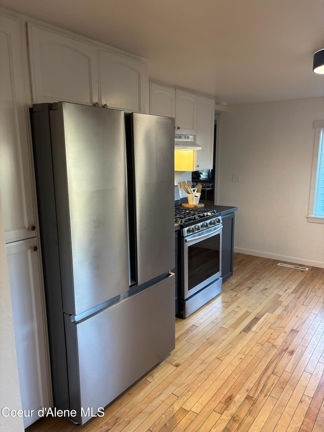 kitchen with white cabinetry, appliances with stainless steel finishes, and light hardwood / wood-style flooring