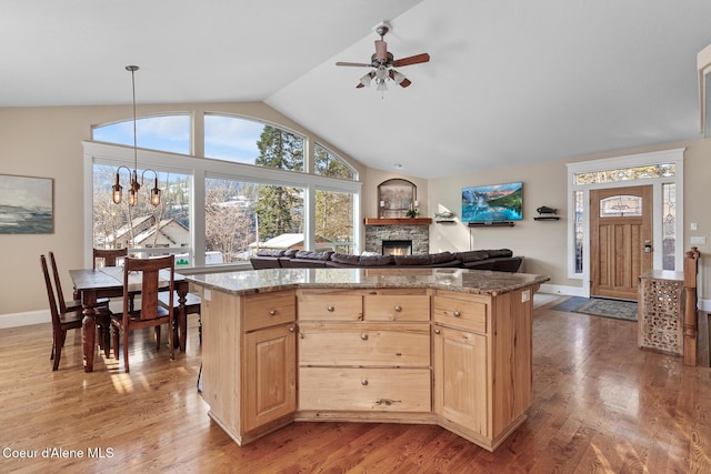 kitchen featuring hardwood / wood-style flooring, pendant lighting, light brown cabinets, and a center island