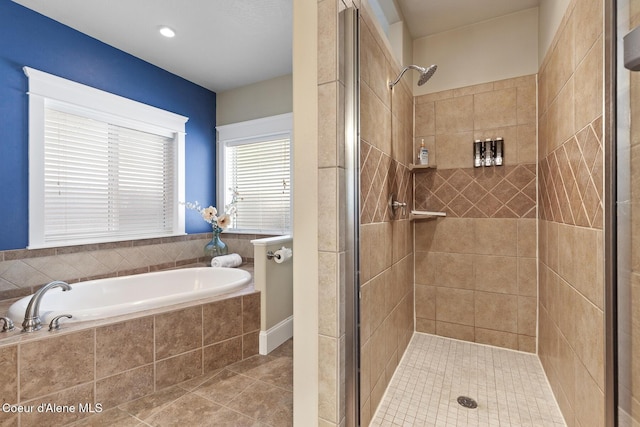 bathroom with tile patterned floors and independent shower and bath