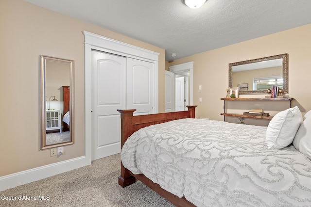 carpeted bedroom featuring a textured ceiling