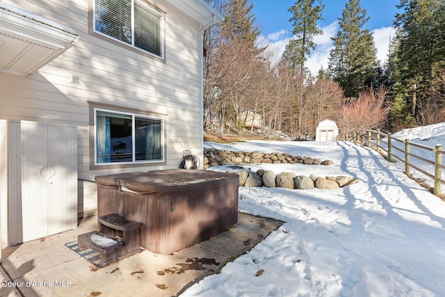 snow covered patio with a hot tub