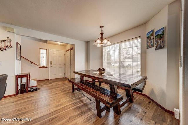 dining space featuring an inviting chandelier and hardwood / wood-style flooring