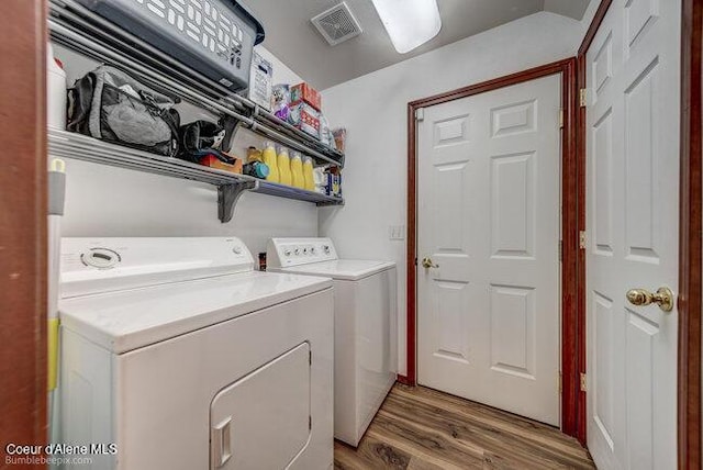 washroom featuring dark wood-type flooring and washing machine and clothes dryer