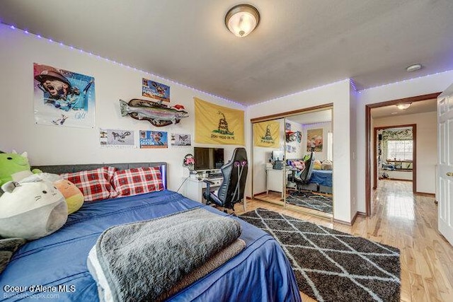 bedroom with hardwood / wood-style flooring and a closet