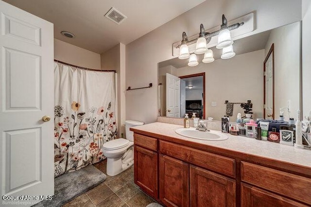 bathroom featuring toilet and vanity