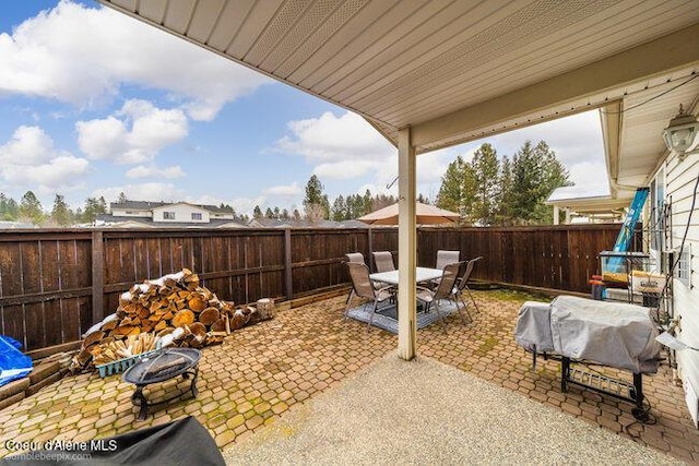 view of patio with grilling area and an outdoor fire pit