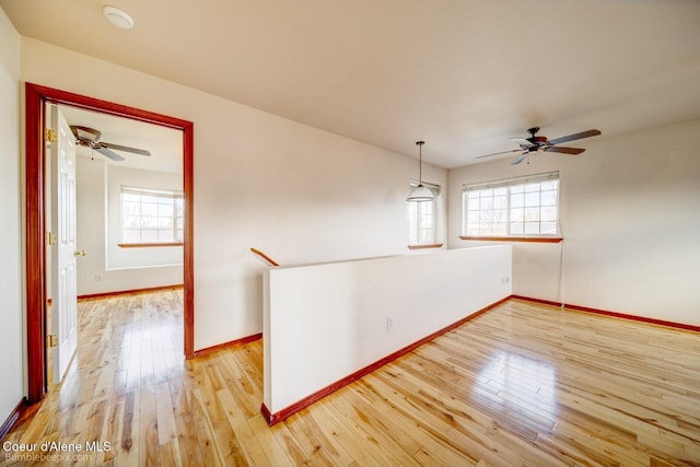 empty room featuring light hardwood / wood-style floors and ceiling fan