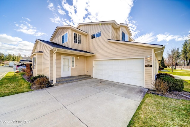 view of front of house with a garage and a front yard