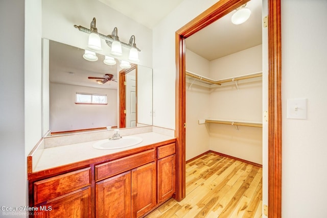 bathroom featuring ceiling fan, vanity, and hardwood / wood-style flooring