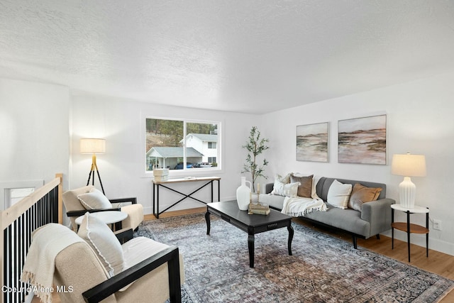 living room with a textured ceiling and hardwood / wood-style flooring