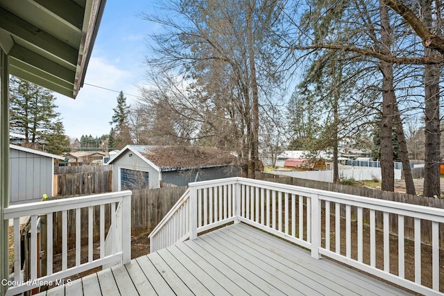 deck with a garage and an outbuilding