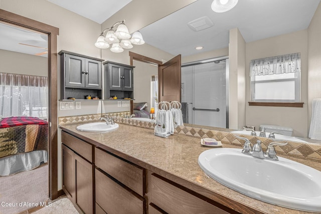 bathroom with vanity, a wealth of natural light, a shower with door, and toilet