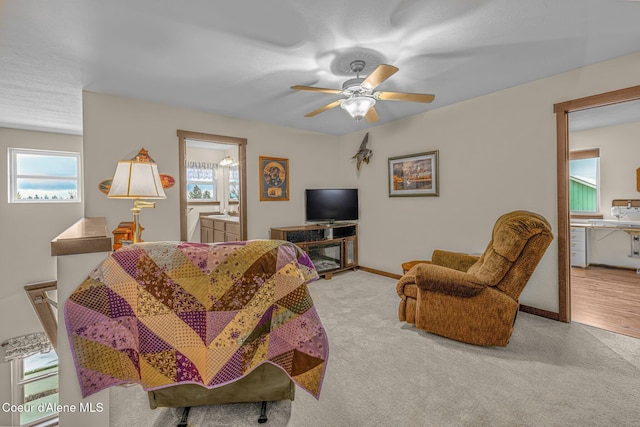 carpeted living room with ceiling fan