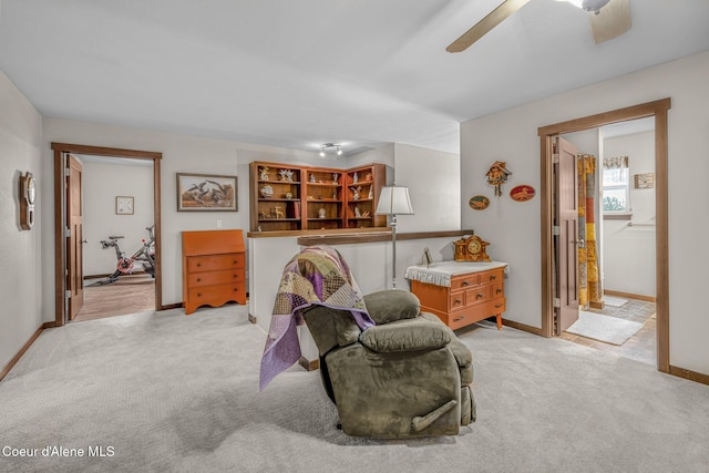 sitting room with light carpet and ceiling fan