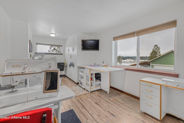 kitchen featuring light hardwood / wood-style flooring, white cabinets, and plenty of natural light