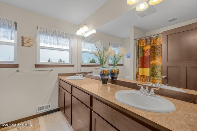 bathroom featuring tile patterned flooring and vanity