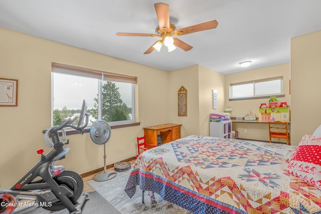 bedroom with multiple windows and ceiling fan