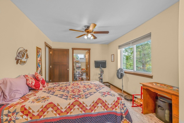 bedroom with ceiling fan and multiple windows