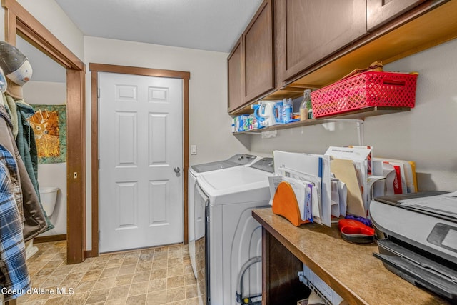 washroom with cabinets and washing machine and dryer