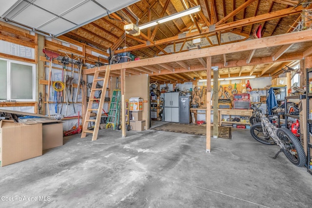 garage with a garage door opener and a workshop area