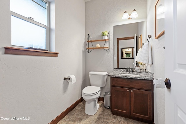 bathroom with toilet and vanity