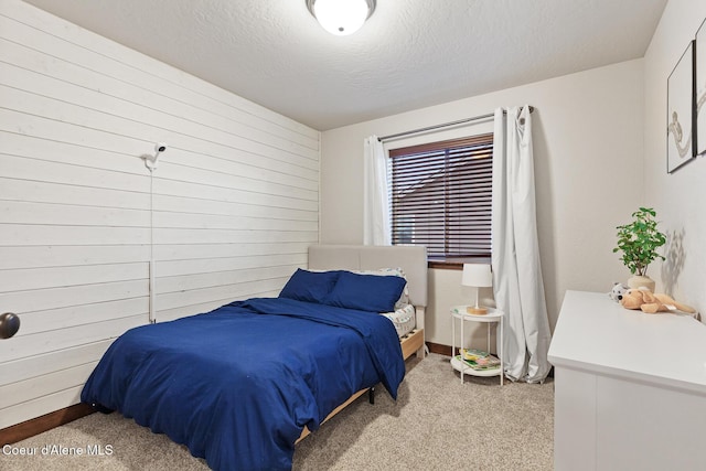 carpeted bedroom with a textured ceiling