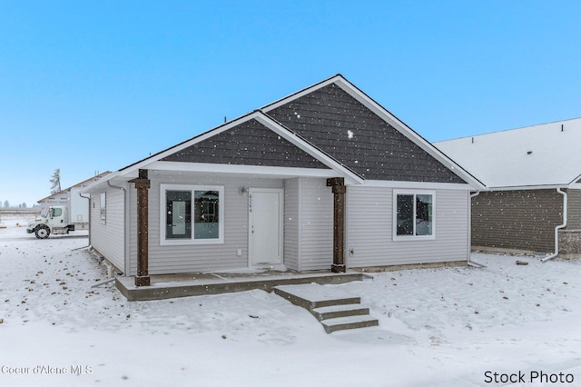 view of snow covered rear of property