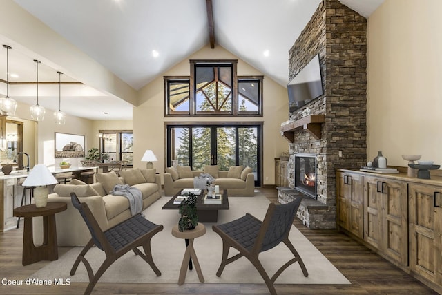 living room featuring dark hardwood / wood-style flooring, a fireplace, high vaulted ceiling, and beamed ceiling