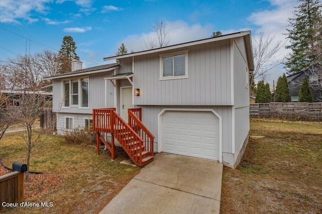 bi-level home with a garage and a front yard