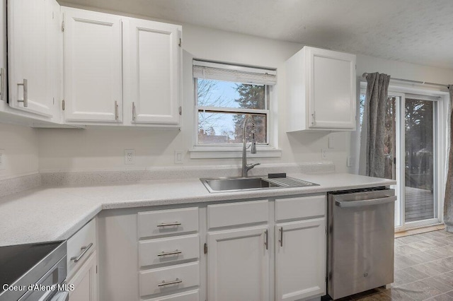 kitchen featuring white cabinetry, dishwasher, and sink