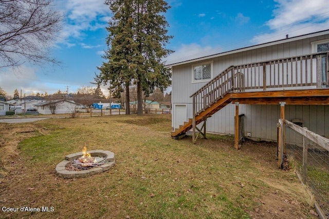 view of yard featuring a wooden deck and a fire pit