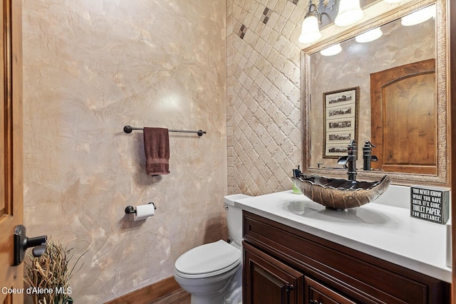 bathroom with toilet and vanity